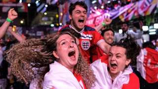 Fans at BOXPARK in Croydon celebrate England reaching the final after watching the Euro 2020 semi final match between England and Denmark.