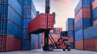 Forklift lifts large container
