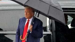Trump with umbrella