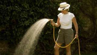 Woman with hosepipe