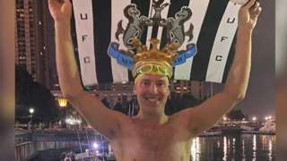 Tony Rutter in NYC with his Newcastle United flag aloft