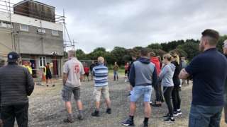 People stood outside of the clubhouse