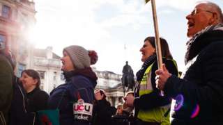 UCU members in London hold signs and chant