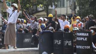Demonstrators shout slogans as they gather on the street during an anti-coup protest in Mandalay, Myanmar, 05 March 2021.