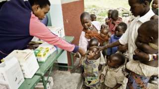 African children line up to receive medication