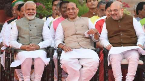 Narendra Modi (L) looks on as he sits next to Bharatiya Janata Party President Amit Shah (2R) and Minister of Home Affairs of India Rajnath Singh (2L) before Modi"s swearing-in ceremony as Indian Prime Minister at the President house in New Delhi on May 30, 2019