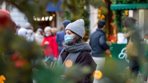 Woman wears face mask in street
