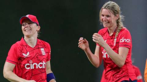 Heather Knight (left) and Lauren Bell smiling as Bell takes a wicket v West Indies