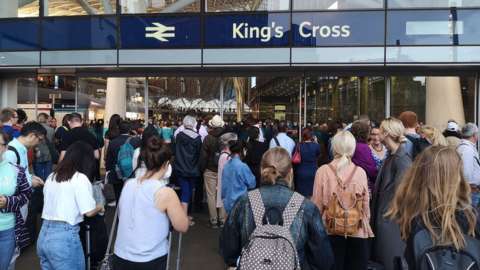 Passengers queuing after a power cut at King's Cross station
