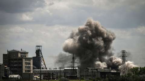 Smoke rises above a factory in Soledar after an attack in the eastern Ukrainian region of Donbas