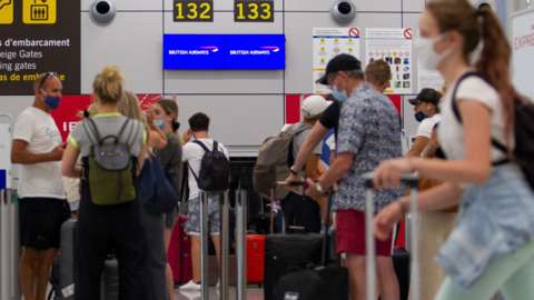 Passengers check-in for flights back to the UK at an airport in Mallorca
