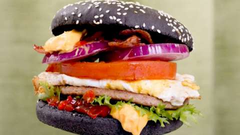 A burger in a black bun