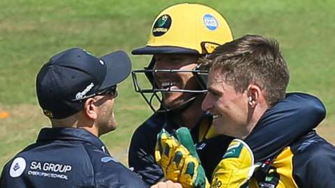 Andy Gorvin (L) celebrates a wicket with Glamorgan teammates