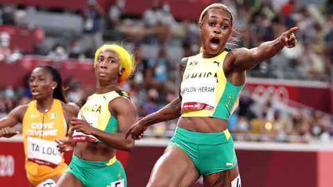 Elaine Thompson-Herah wins the women's 100m final as Shelly-Ann Fraser-Pryce looks on