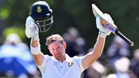 South Africa opener Sarel Erwee raises his helmet and bat after hitting his maiden Test ton against New Zealand