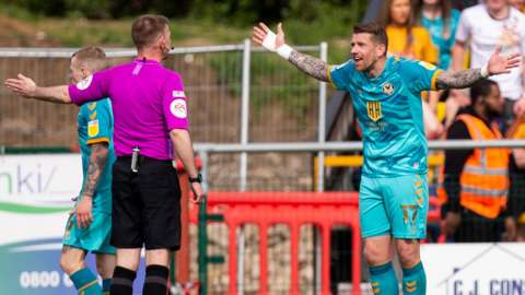 Newport's Scot Bennett protests after conceding a penalty