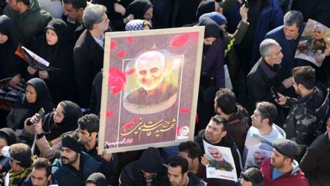 Mourners attend the burial of Qasem Soleimani