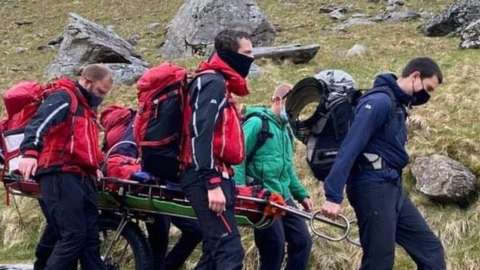 The woman being transported down Snowdon by members of the Llanberis Mountain Rescue Team
