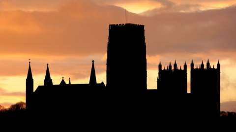 Durham Cathedral silhouetted against sunset