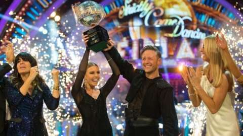 Stacey Dooley and Kevin Clifton lift the Strictly glitterball trophy