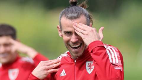 Gareth Bale shares a joke in Wales training