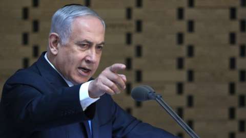 Mr Netanyahu points into the crowd from a podium in this 10 October image