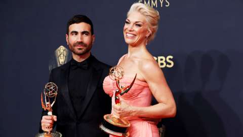 Brett Goldstein and Hannah Waddington pose with their Emmy awards for Ted Lasso