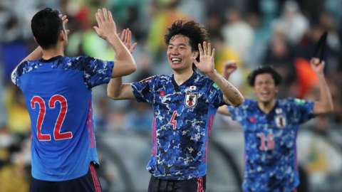 Kou Itakura of Japan (C) celebrates victory with Maya Yoshida (L)
