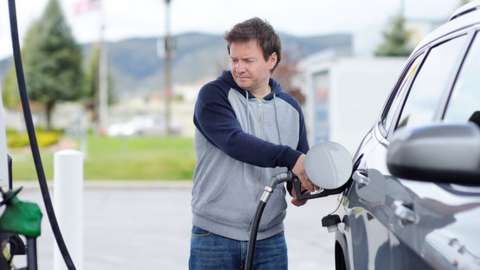 Man filling up car with fuel