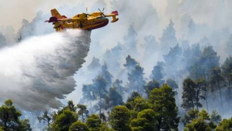 Plane drops water on Evia fires