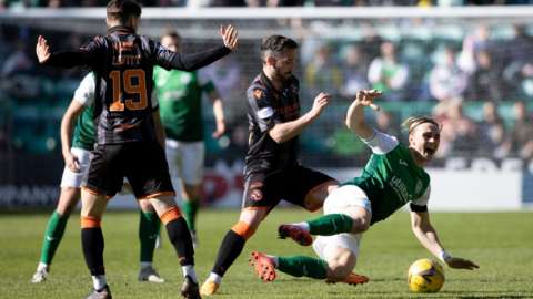 Hibernian's Elias Melkersen (R) and Dundee United's Nickly Clark during a cinch Premiership match between Hibernian and Dundee United at Easter Road,