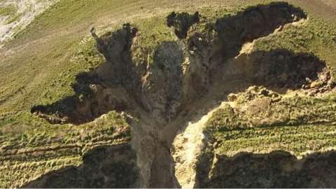 An expert says it was not caused by the sea but by water rushing off the cliff after heavy rain.