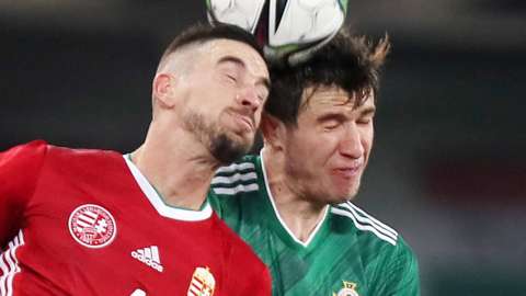 Hungary's Zsolt Nagv and Paddy McNair contest a high ball