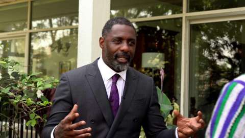 Idris Elba giving an interview to the BBC in Sierra Leone