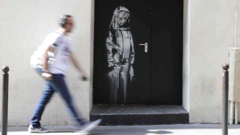 An artwork by street artist Banksy in Paris, on a side street to the Bataclan concert hall