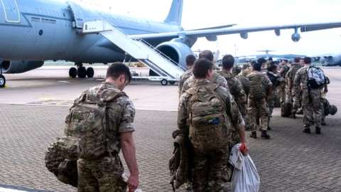 British military personnel board an RAF Voyager aircraft to travel to Afghanistan