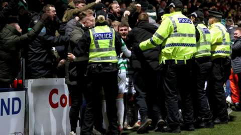 Celtic player Anthony Ralston in front of away fans after scoring Celtic's second goal