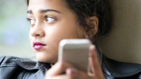 Teenage girl on her mobile phone