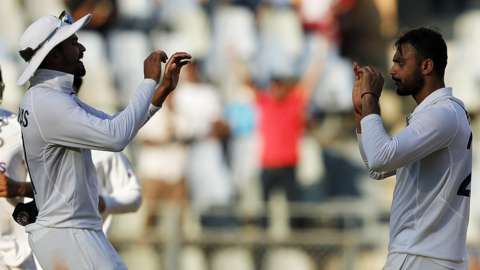 India's Axar Patel celebrates taking a New Zealand wicket