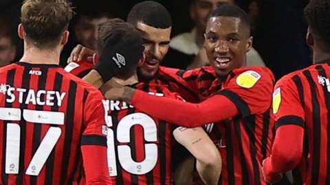 Bournemouth's players celebrate their opening goal against Cardiff
