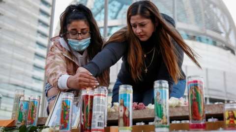 Mourners light candles at a vigil for victims of the rail yard shooting in San Jose, May 2021