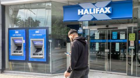 Man walking past Halifax bank