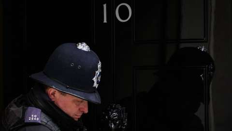 A police officer leaves number 10, Downing Street in London, England