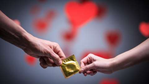 Pair holding a condom