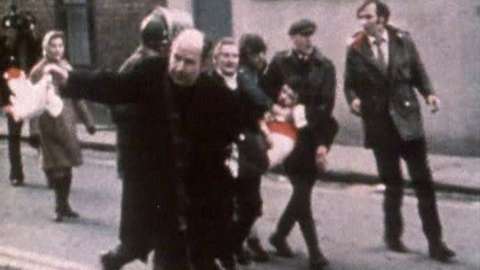 Fr Edward Daly waves a white handkerchief as Jackie Duddy is carried away on Bloody Sunday, 30 January 1972