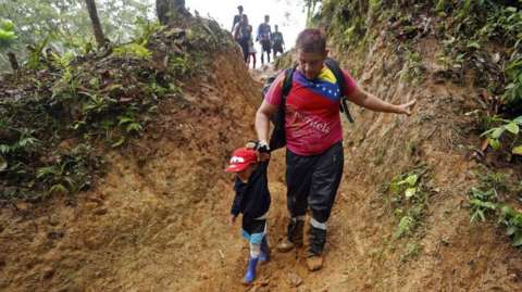 Migrants walk through a mountain with the intention of reaching Panama, through the Darien Gap, Colombia, on 08 October 2022
