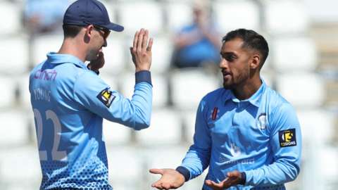 Saif Zaib of Northamptonshire Steelbacks celebrates with Will Young after taking the wicket of David Lloyd