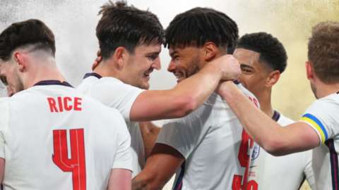 England players embrace with Harry Maguire