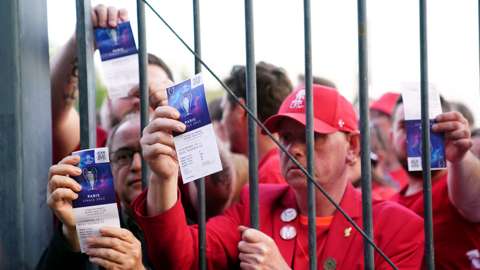 Liverpool fans show their tickets in Paris