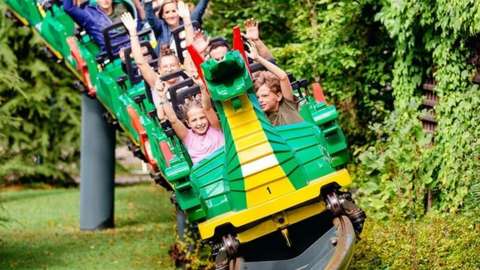 Image shows children on rollercoaster